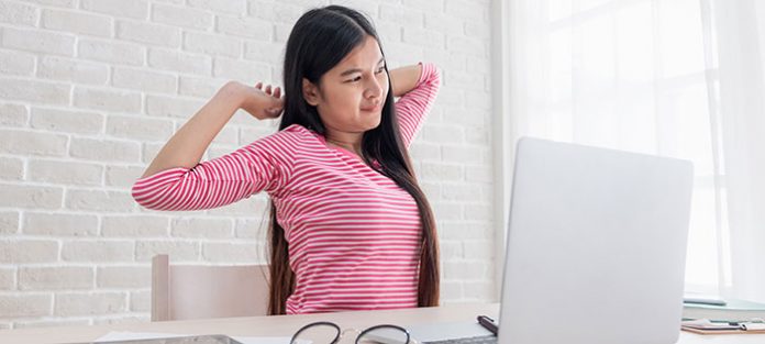 girl stretching at desk