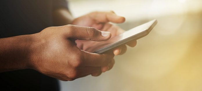 Male hands holding mobile phone