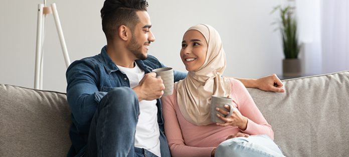 happy Muslim couple relaxing at home