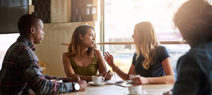 group of friends having serious conversation in cafe