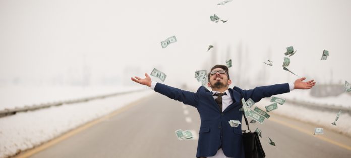 young man tossing cash in air