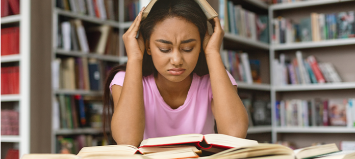 stressed student at the library | how to get back on track after a bad semester