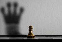 Chess pawn casting a shadow in the shape of a queen, symbolizing potential and confidence.