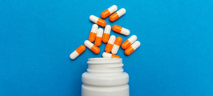 bottle of pills spilling on to table