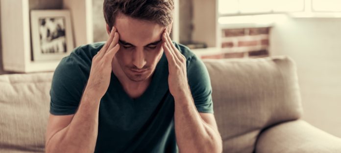 Guy holding his head