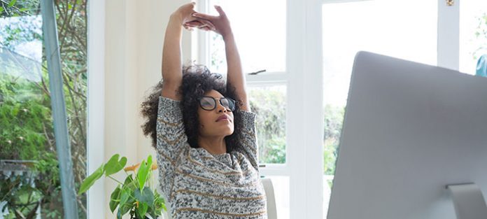 Girl stretching at her desk