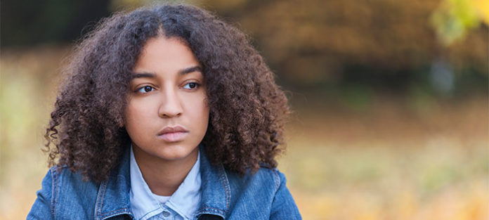 Sad young female sitting outside
