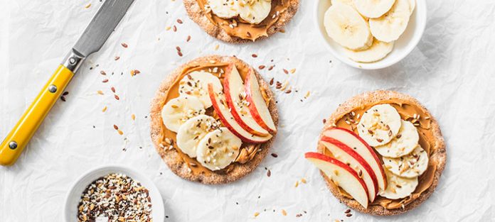 rice cakes with peanut butter, banana, and apple