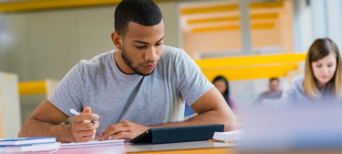 young black male taking test in classroom