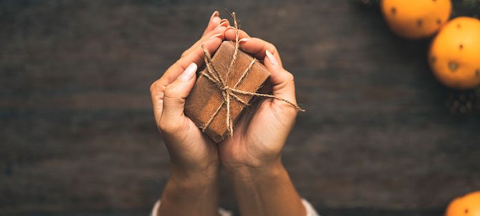 Hands holding a wrapped box