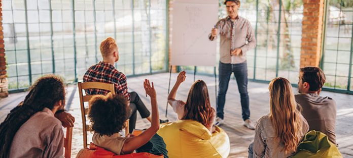 Professor-making-a-presentation-for-a-group-of-students Professor-making-a-presentation-for-a-group-of-students